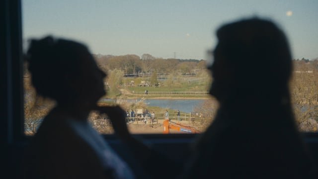 Becca and Ryan's cinematic wedding film — couple in silhouette looking out across a sunlit view